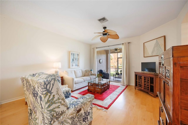 living room featuring ceiling fan and light hardwood / wood-style flooring