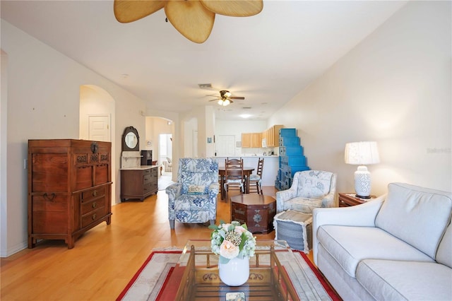 4209 Cascade Falls Dr, Sarasota, FL 34243 - living area featuring a ceiling fan, arched walkways, and light wood-style floors