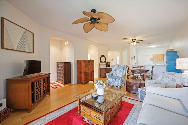 4209 Cascade Falls Dr, Sarasota, FL 34243 - living room with a ceiling fan, arched walkways, and wood finished floors