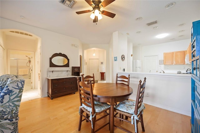 4209 Cascade Falls Dr, Sarasota, FL 34243 - dining space featuring arched walkways, a ceiling fan, and light wood-style floors