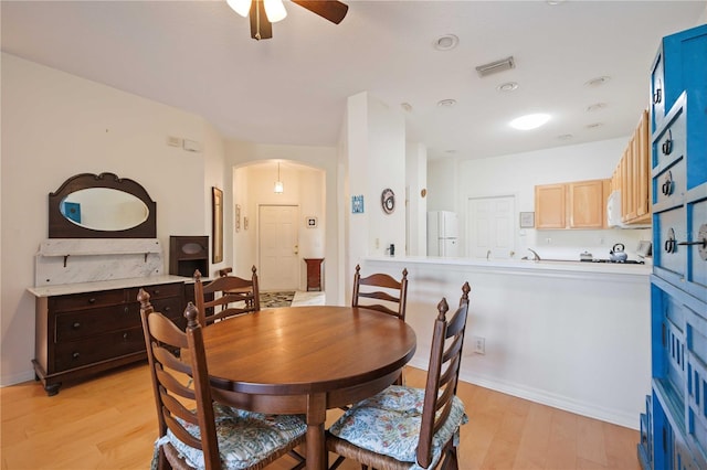 dining area featuring ceiling fan and light hardwood / wood-style flooring