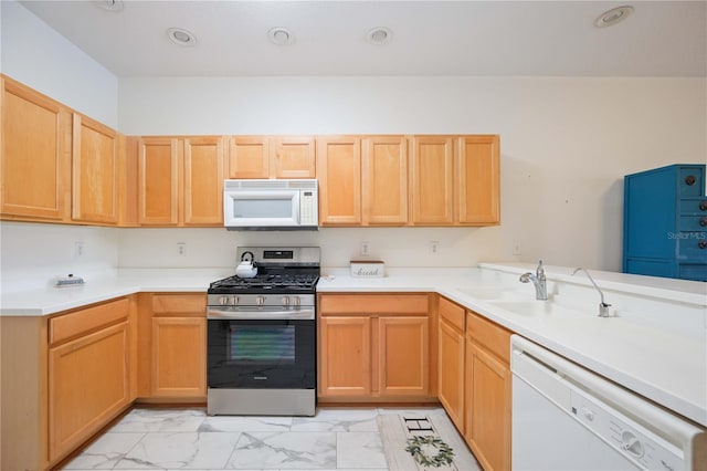 4209 Cascade Falls Dr, Sarasota, FL 34243 - kitchen with white appliances, light marble finish floors, light countertops, light brown cabinets, and a sink