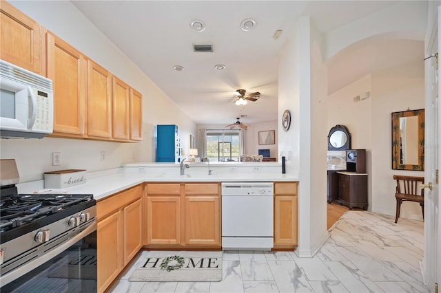 4209 Cascade Falls Dr, Sarasota, FL 34243 - kitchen with white appliances, light marble finish floors, a ceiling fan, light countertops, and light brown cabinets
