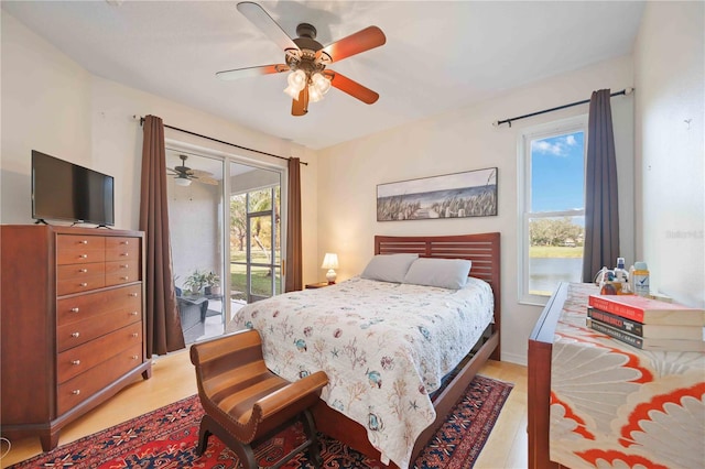 bedroom featuring multiple windows, ceiling fan, light hardwood / wood-style flooring, and access to exterior