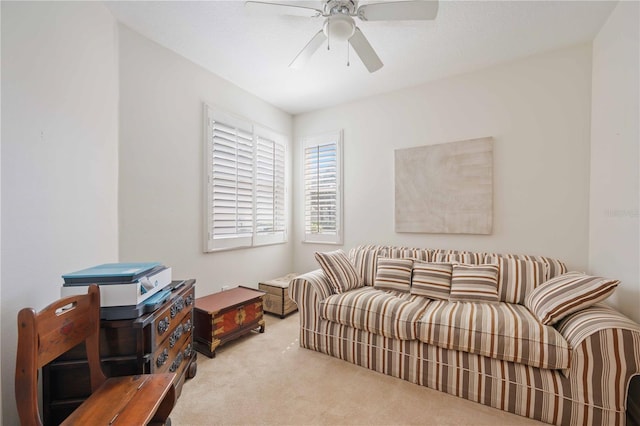 living room featuring ceiling fan and carpet