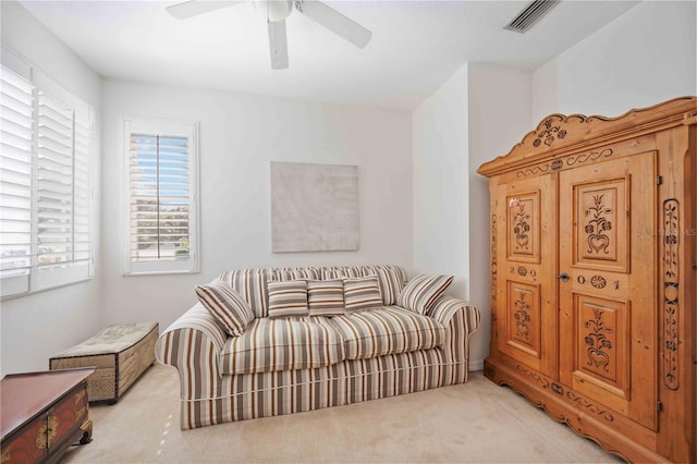 sitting room with light colored carpet and ceiling fan