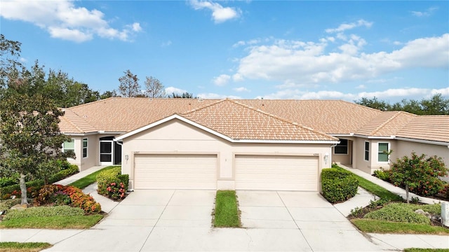 4209 Cascade Falls Dr, Sarasota, FL 34243 - single story home with a tiled roof, stucco siding, a garage, and concrete driveway