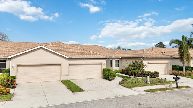 4209 Cascade Falls Dr, Sarasota, FL 34243 - view of front of home featuring stucco siding, a tiled roof, driveway, and an attached garage