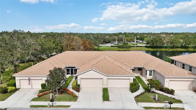 4209 Cascade Falls Dr, Sarasota, FL 34243 - view of front of home featuring a tile roof, stucco siding, concrete driveway, a water view, and an attached garage