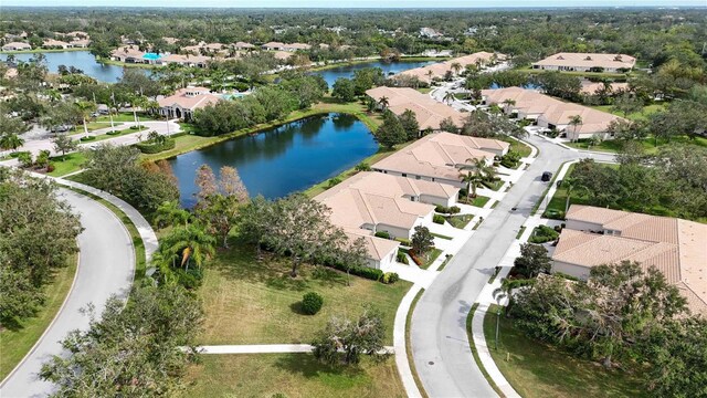 4209 Cascade Falls Dr, Sarasota, FL 34243 - aerial view of property and surrounding area featuring nearby suburban area, a nearby body of water, and a tree filled landscape