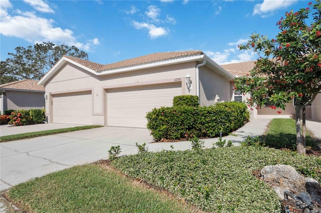 4209 Cascade Falls Dr, Sarasota, FL 34243 - ranch-style home with concrete driveway, a garage, stucco siding, and a tile roof