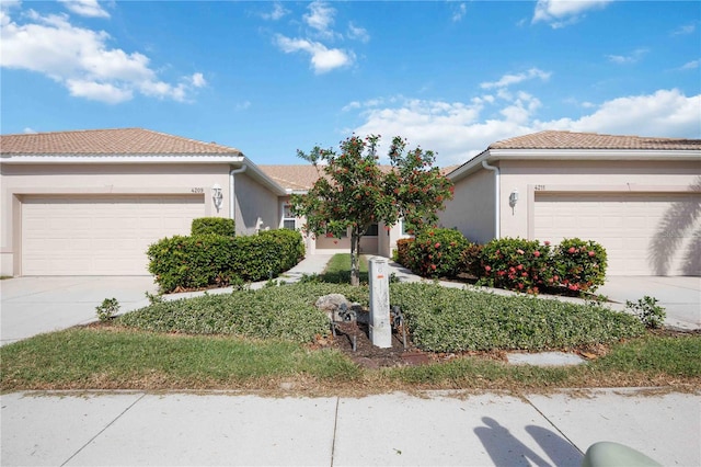 4209 Cascade Falls Dr, Sarasota, FL 34243 - single story home with an attached garage, driveway, and stucco siding