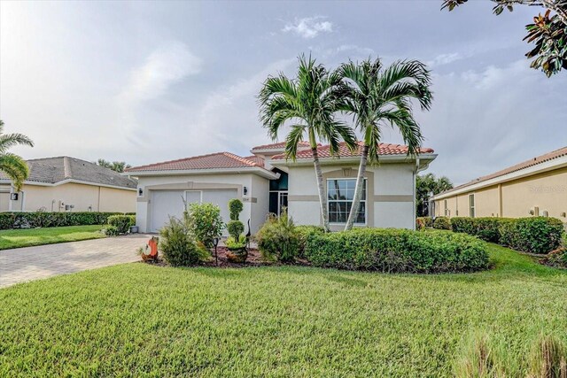 3264 Magnolia Landing Ln, North Fort Myers, FL 33917 - mediterranean / spanish home with stucco siding, a front lawn, a garage, driveway, and a tiled roof