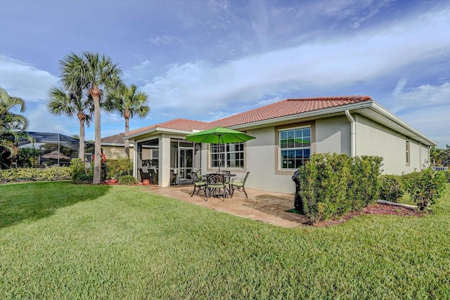 back of house with a lawn and a patio area