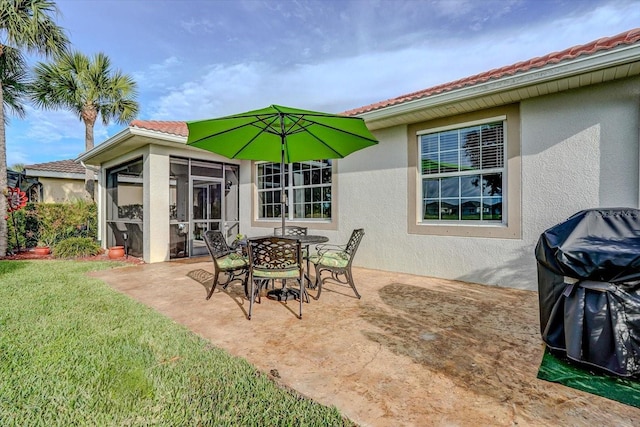 view of patio / terrace featuring a sunroom