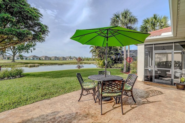 view of patio featuring a sunroom and a water view