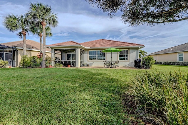 back of house featuring a lawn, a patio area, and a sunroom