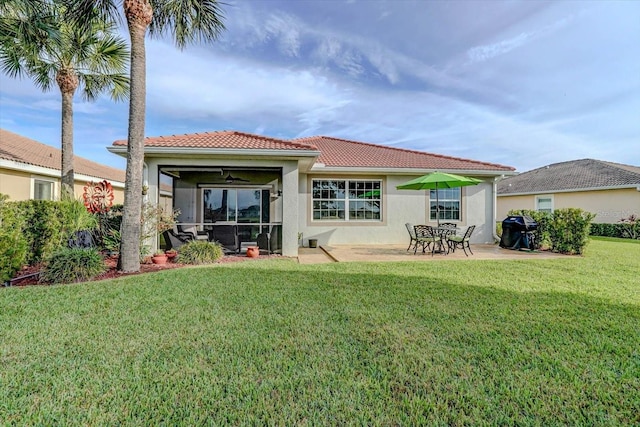 rear view of house featuring a patio and a lawn