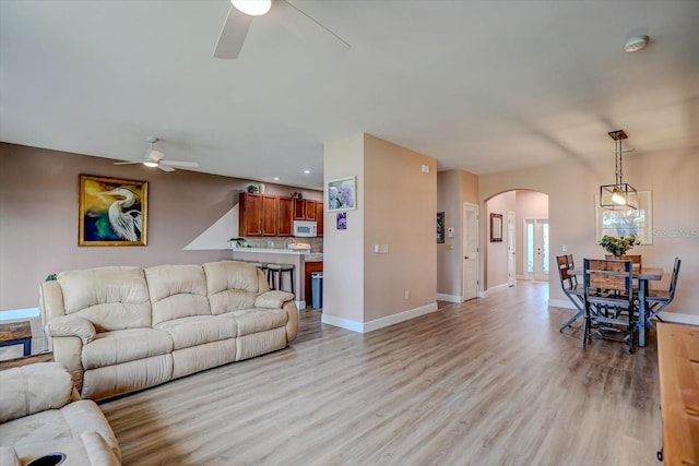 living room featuring light hardwood / wood-style flooring and ceiling fan