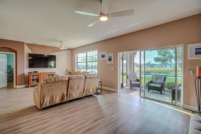 living room featuring light hardwood / wood-style flooring and ceiling fan