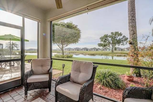 sunroom / solarium with a water view