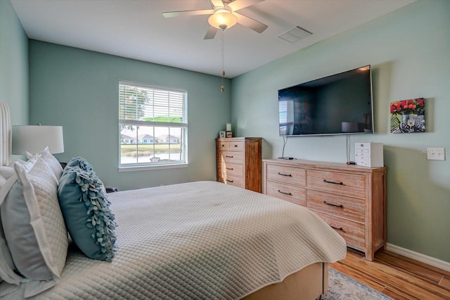 bedroom with ceiling fan and light hardwood / wood-style floors