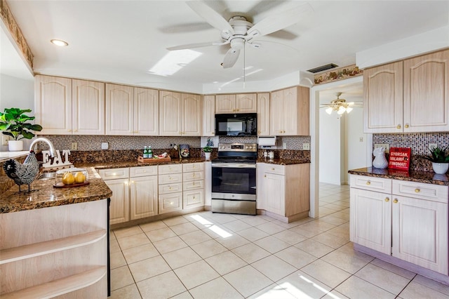 kitchen featuring decorative backsplash, light brown cabinets, electric range, and dark stone countertops