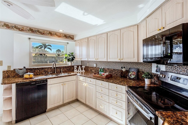 kitchen featuring decorative backsplash, sink, dark stone counters, and black appliances