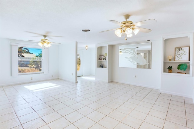 tiled spare room featuring ceiling fan and built in features