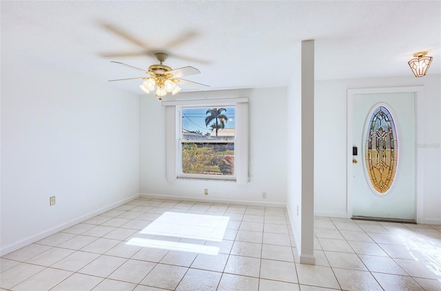 tiled foyer with ceiling fan