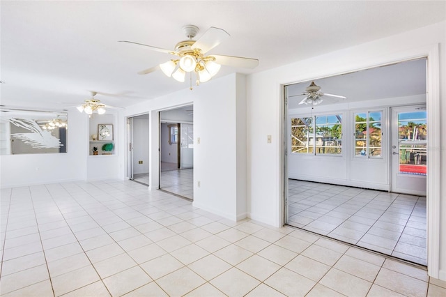 spare room featuring light tile patterned floors and a chandelier