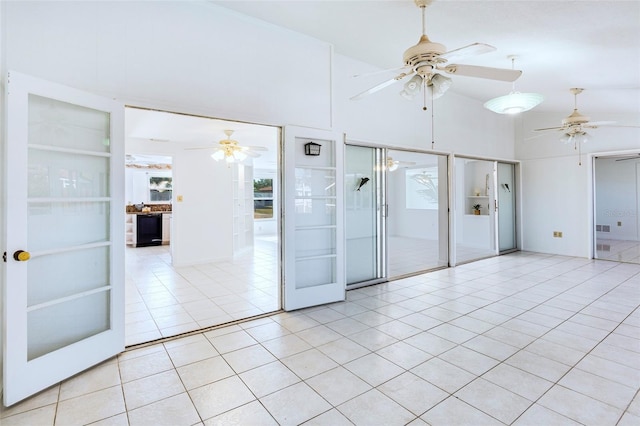 unfurnished room featuring built in features, light tile patterned floors, and french doors