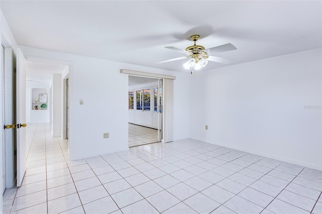 unfurnished room featuring ceiling fan and light tile patterned floors