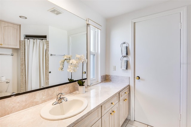 bathroom featuring tile patterned flooring and vanity