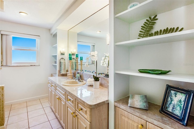 bathroom featuring tile patterned flooring, vanity, and a healthy amount of sunlight