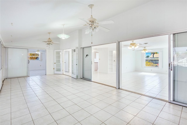 tiled empty room featuring built in features and lofted ceiling