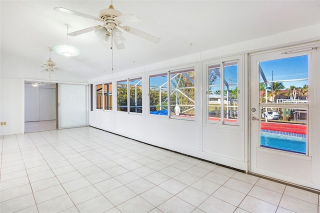 unfurnished sunroom featuring ceiling fan