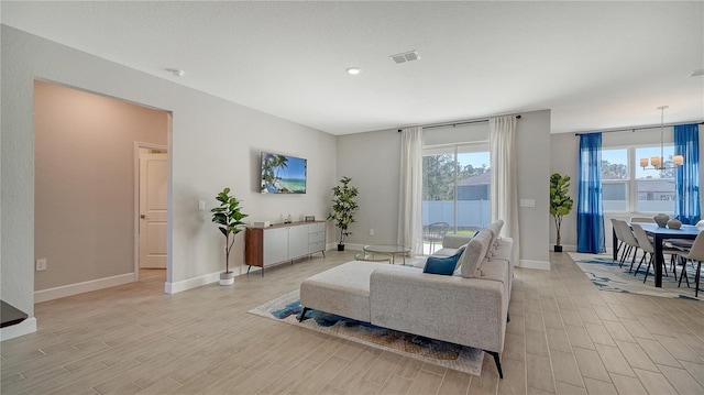 living room featuring a notable chandelier