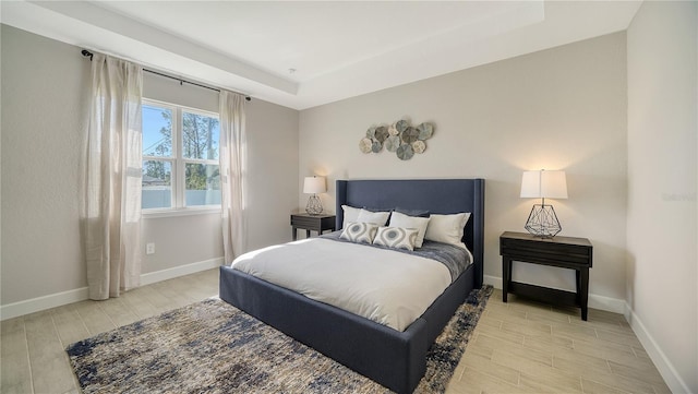 bedroom featuring a raised ceiling