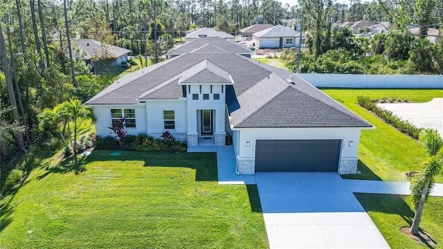 view of front of home with a front yard and a garage