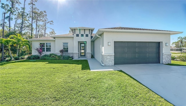 view of front of property featuring a front lawn and a garage