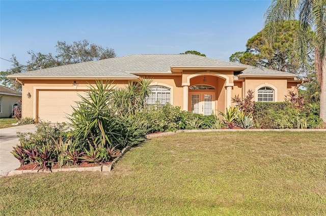 view of front of property with a garage and a front lawn