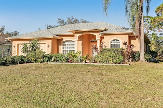 view of front of home with a garage and a front lawn