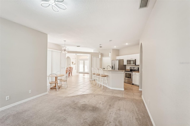 unfurnished living room featuring light colored carpet and sink