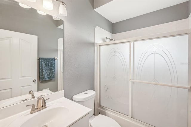 full bathroom with vanity, toilet, and bath / shower combo with glass door