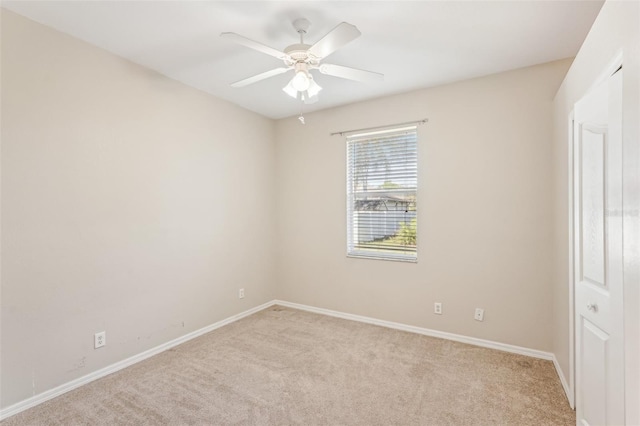 empty room with light carpet and ceiling fan