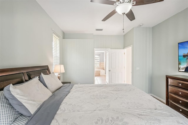 bedroom with ensuite bath and ceiling fan