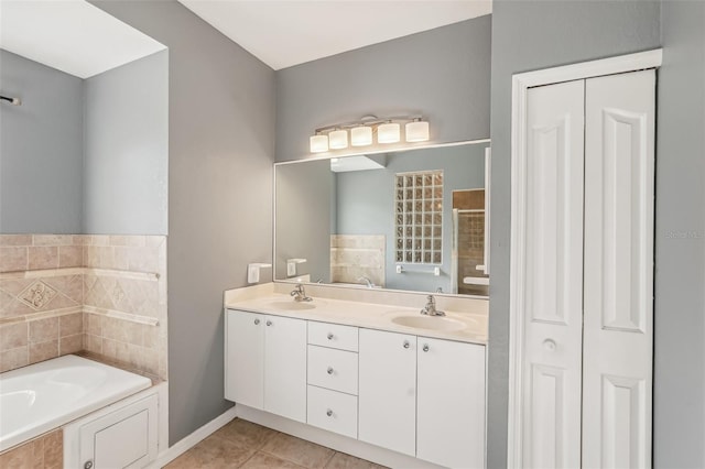 bathroom featuring a tub, tile patterned flooring, and vanity