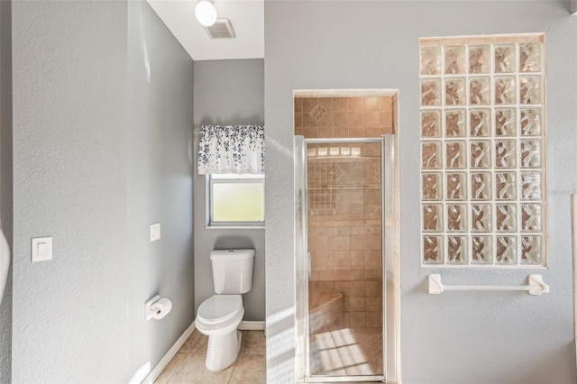 bathroom with tile patterned flooring, an enclosed shower, and toilet