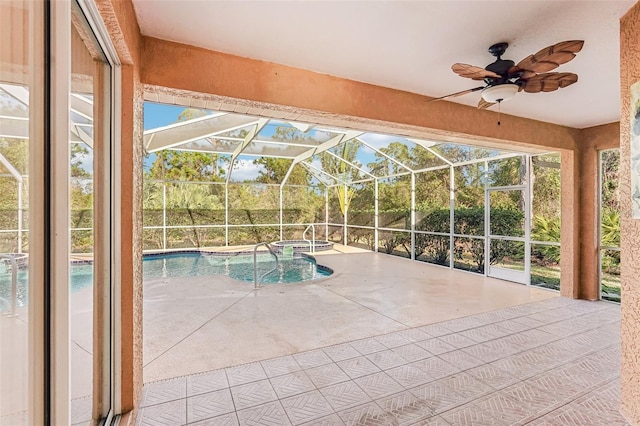 view of pool with a patio area, ceiling fan, glass enclosure, and an in ground hot tub